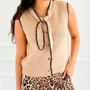 NWT Entro sweater vest with black stitching trim.